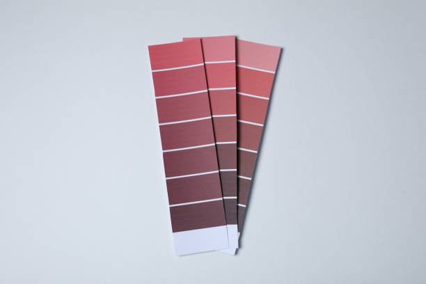 istock Color paint chips of red shades on light background, top view 1756765904