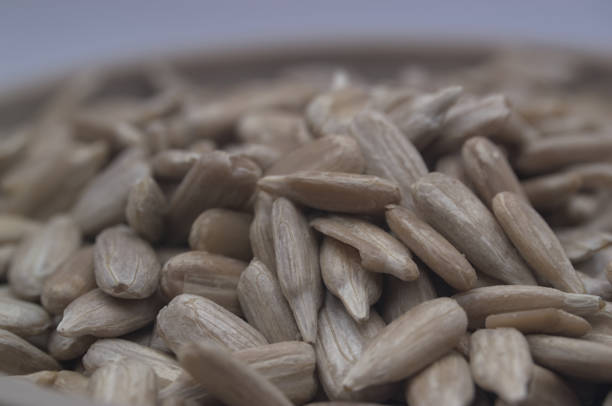istock Raw unsalted peeled and unpeeled seeds on white background and soft light. 1756778805