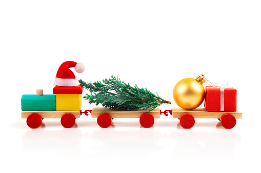 Toy train with Christmas ornaments isolated on white