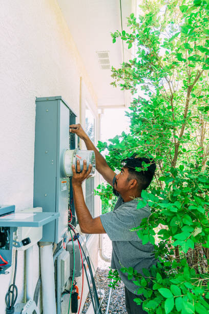 istock Electrician Installing a Circuit Breaker Overhead in a Panel for a DIY Solar Installation on a Suburban Home in the USA 1756794587