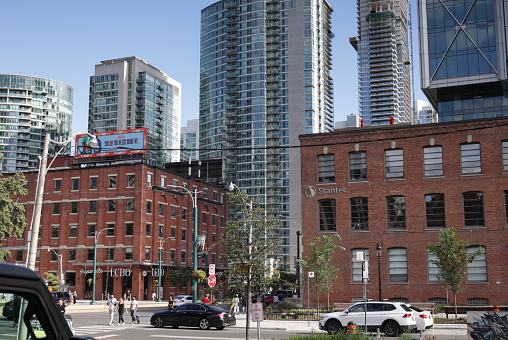 Toronto, Canada - August 27, 2023: Looking southeast on the 400-block of Wellington Street West to the office and residential buildings in the Wellington Place district. Summer afternoon with clear skies.
