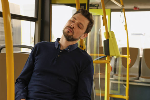 istock Tired man sleeping while sitting in public transport 1756814740