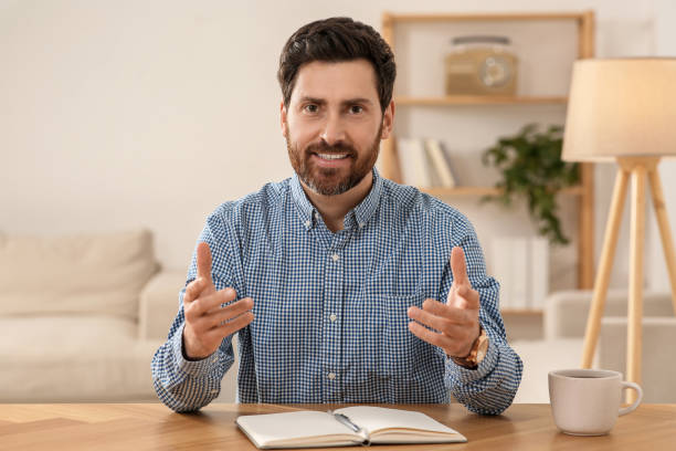 istock Happy man using video chat at wooden desk indoors, view from web camera 1756815633