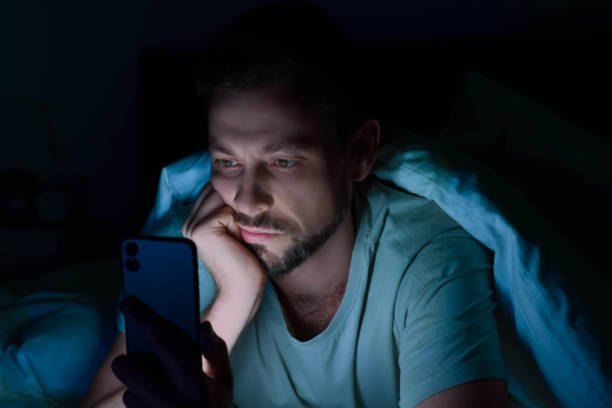 istock Man using smartphone in bed at night. Internet addiction 1756816868