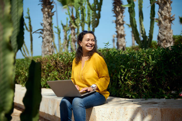 istock Smiling happy female student looking aside while studying online using a laptop. People and education concept 1756825864