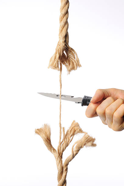istock Cutting a rope with knife against white background 175682704