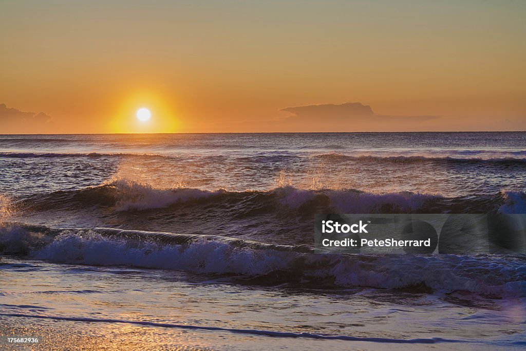 Sunset seascape An evening seascape. Sunlight catches the spray on the crest of ocean waves. Beach Stock Photo