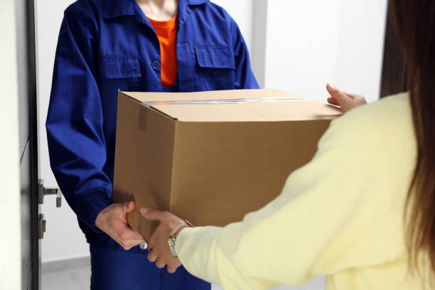 istock Woman receiving parcel from courier indoors, closeup 1756834704