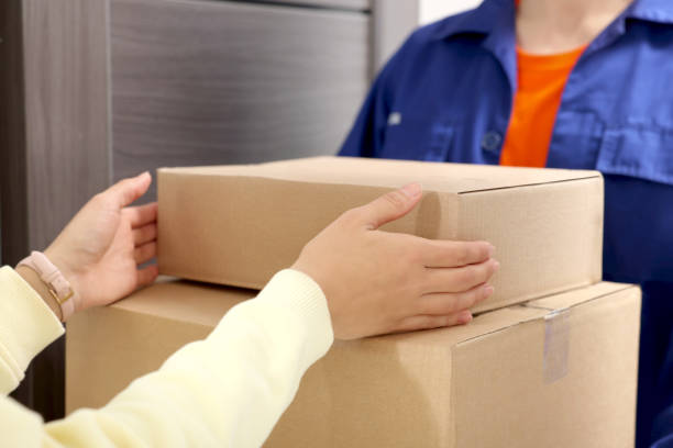 istock Courier giving parcels to woman indoors, closeup 1756835443