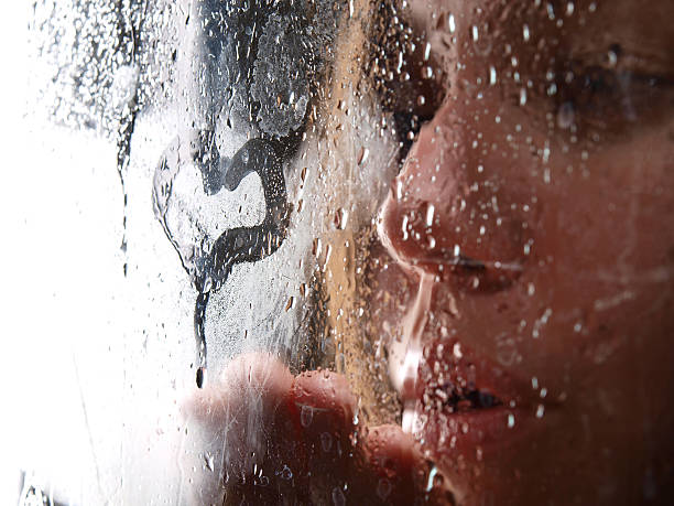istock Portrait woman behind wet window 175683637