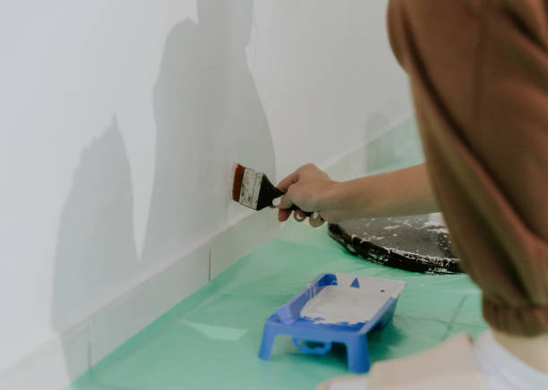 istock A young girl paints a wall with a brush. 1756856060