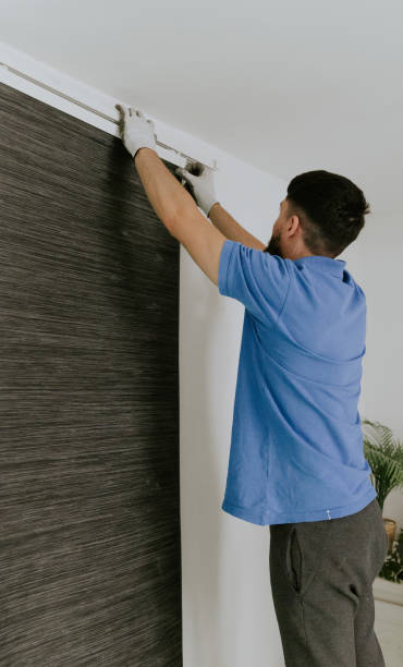 istock A young man removes the curtain rod. 1756856076