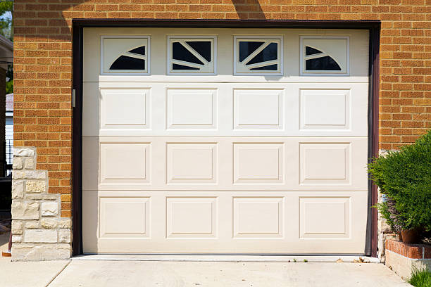 istock White electric garage door with upper windows 175685948