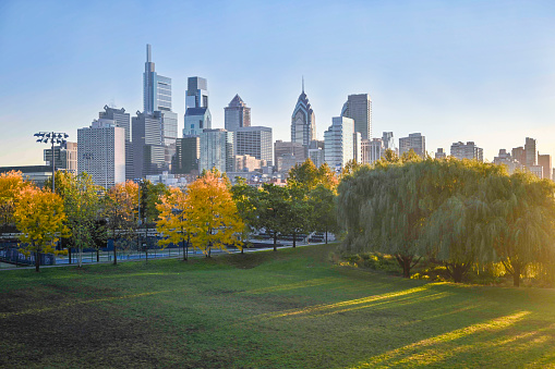 Center city Philadelphia, skyline. Autumn. Colorful trees in the foreground with grass empty field.