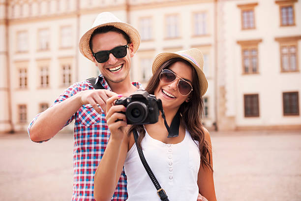 istock Smiling couple viewing pictures on the camera 175689319