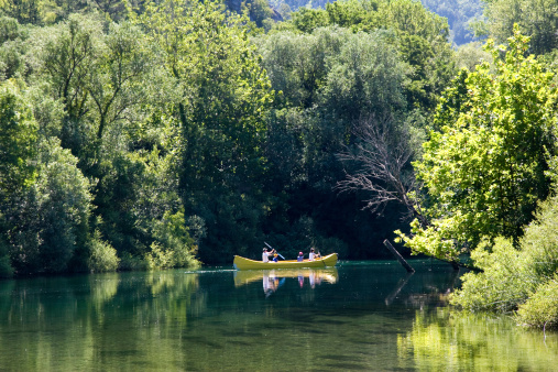 Family are rowing in canoe along the river Cetina in Croatia