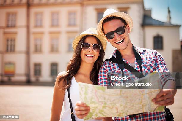 Happy Tourists Couple Holding Map Stock Photo - Download Image Now - Tourist, Tourism, Explorer