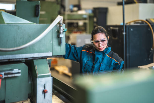 istock Mid Adut Asian Female Factory Worker Operating A Machine 1756949357