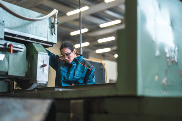 istock Mid Adult Asian Female Blue Collar Worker Operating A Machine 1756949362
