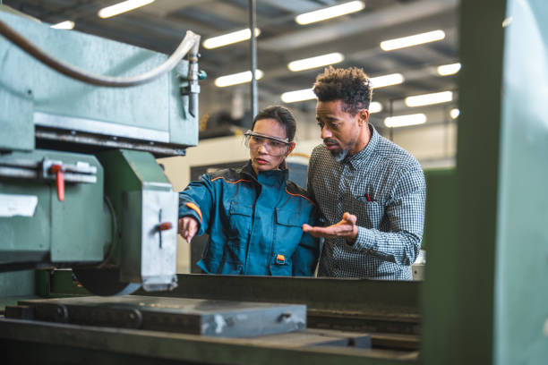 istock Asian Female Blue Collar Worker And Black Male Engineer Collaborating At Work 1756949368