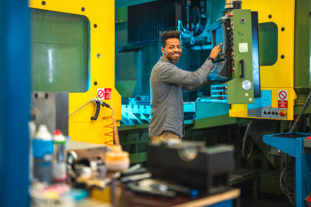 istock Mid Adult Black Male Pressing Control Buttons On A CNC Machine 1756949381