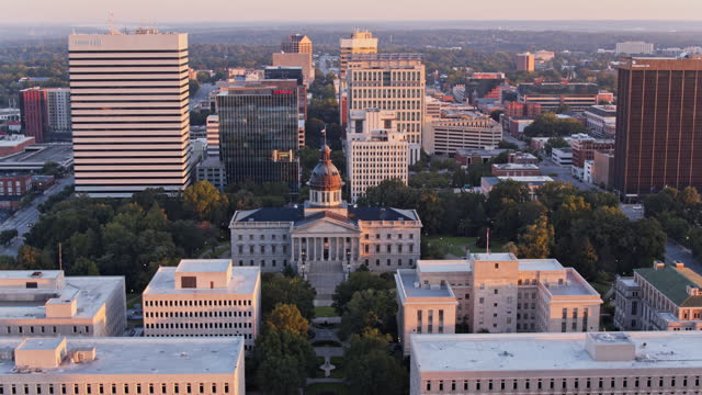 State House is the center of historic Downtown Columbia in South Carolina. Government building stand amidst skyscrapers of Financial District of capital city. Aerial footage with panning camera motion