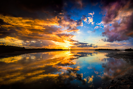 Nature shoot themes: Dramatic morning cloudscape with a reflection on a tropical coastal lagoon.
