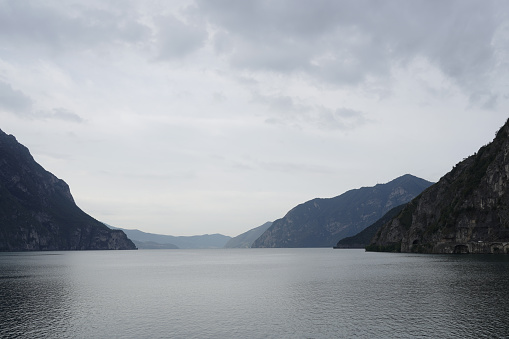 View of a glimpse of Lake Iseo, at the bottom on the left  a piece of Monte Isola, early morning, from Castro area. Italy