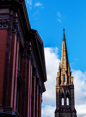 Boston, Massachusetts, USA - October 23, 2023: View from Boylston Street in Boston's Back Bay neighborhood. On the left is RH Boston, a landmark building designed in 1862. RH Boston features artistic installations of home furnishings in a gallery setting. On the right is the Church of the Covenant. A National Historic Landmark, it was built in 1865-1867 by the Central Congregational Church, and is now affiliated with the Presbyterian Church and the United Church of Christ.