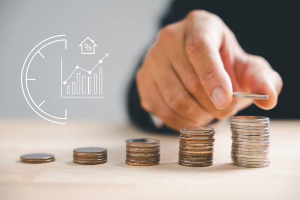 istock Businessman Hand Arranging House Model On Stacked Coins 1757111224