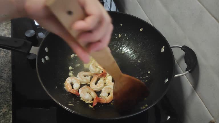 Cooking Stir fried broccoli with shrimp in a hot pan, Close Up Food concept.