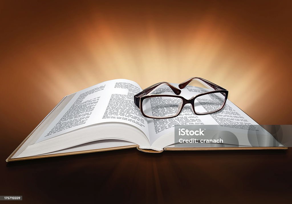 Open Bible, with cross symbol and glasses Accessibility Stock Photo