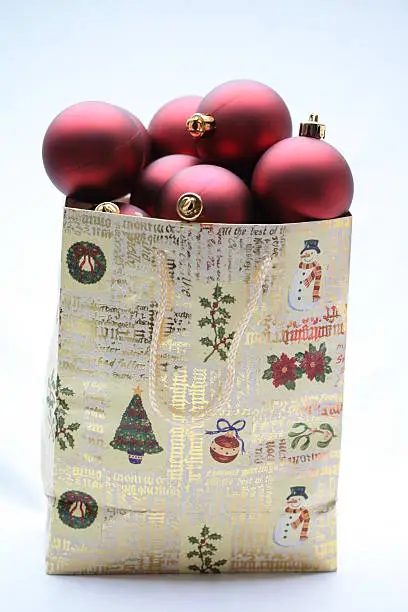 A christmas giftbag with red christmas balls