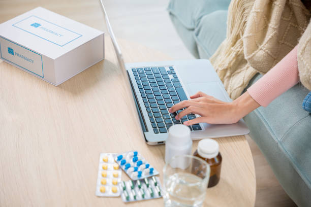 istock Business female sick she taking pills for flu while work with laptop keyboard 1757187896