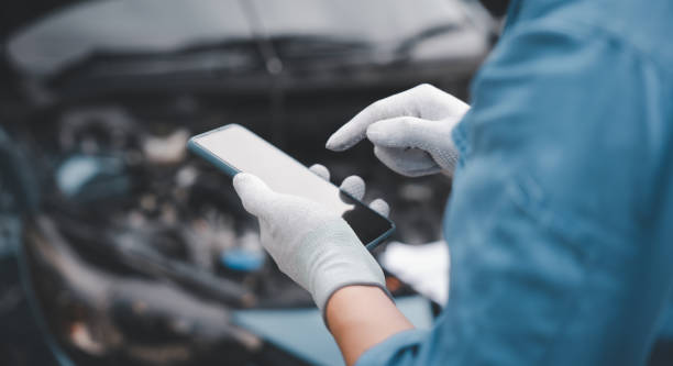 istock Mechanic use smartphone repair car. 1757188462