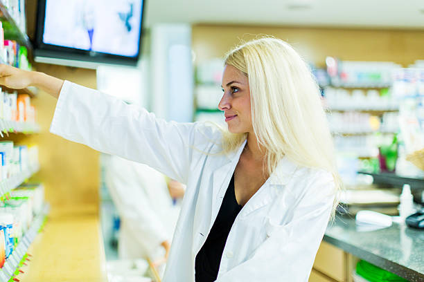 istock Cute female pharmacist at pharmacy checking supplies 175718957