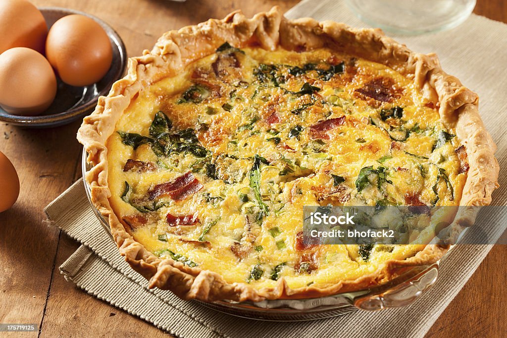 Homemade Spinach and Bacon Egg Quiche Homemade Spinach and Bacon Egg Quiche in a pie crust Bacon Stock Photo