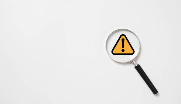 istock Black and yellow triangle caution warning sign inside of magnifier glass for notification error and maintenance concept. 1757211190