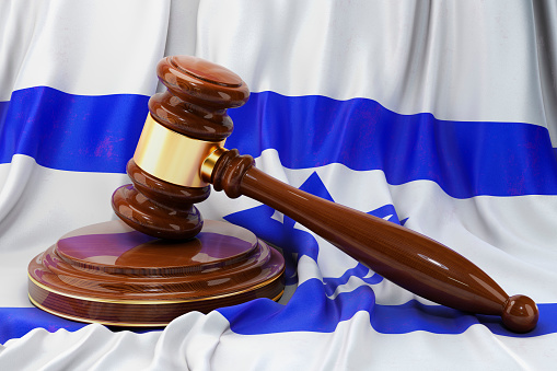 Israeli law and justice concept. Wooden gavel on flag of Israel, 3D rendering