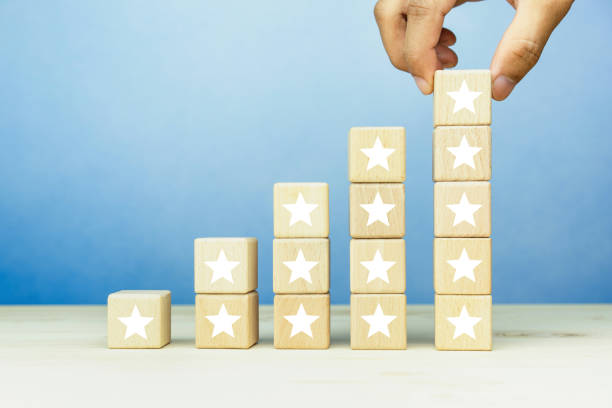 istock Hand put wooden blocks stacking with the five star symbol on the table, evaluation, Increase rating, Customer experience, satisfaction and best excellent services rating concept. 1757217478