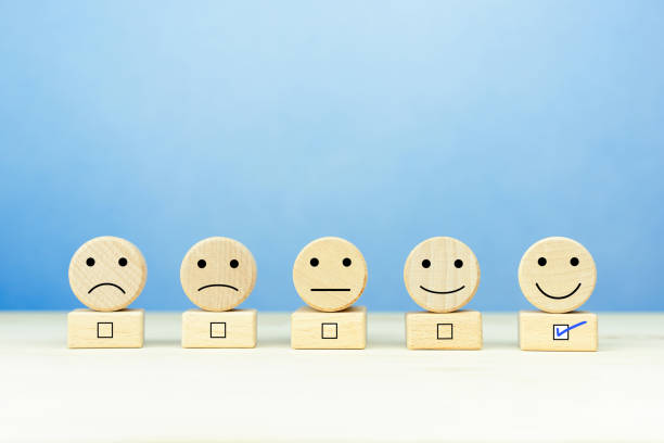istock Customer service evaluation and satisfaction survey concepts. Happy face smile face icon on a wooden ball on table 1757217543