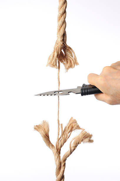 istock Cutting a rope with knife against white background 175722542