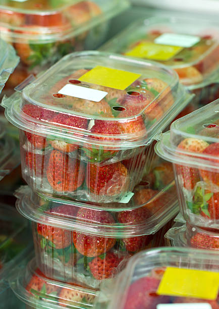 istock Fresh strawberries closed plastic boxes in market. 175723024