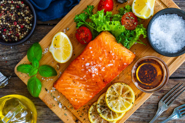 istock Seared salmon with fresh vegetables on wooden table 1757232600