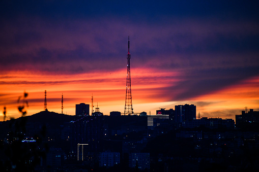 Sunset in the city. The silhouette of the city and the TV tower.