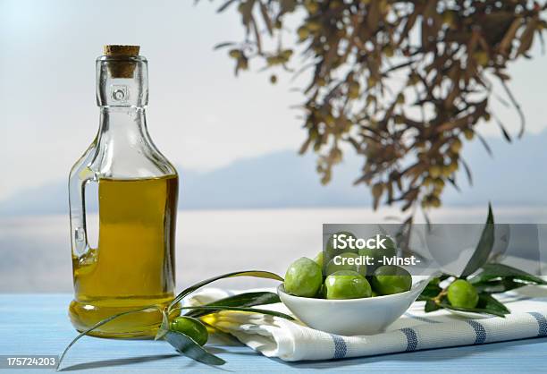 Olives Olive Branch And Olive Oil Stock Photo - Download Image Now - Blue, Bowl, Branch - Plant Part