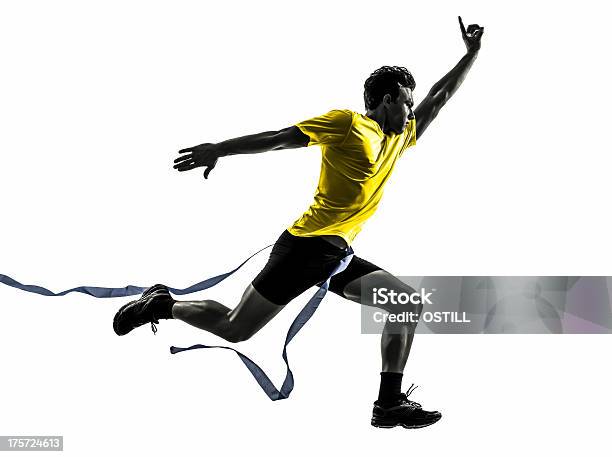 Young Man Sprinter Runner Running Winner Finish Line Silhouette Stock Photo - Download Image Now