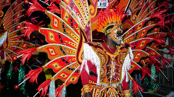 Young man  dressed in bright and vibrant colors at the Boxing Day Junkanoo parade in Nassau, The Bahamas