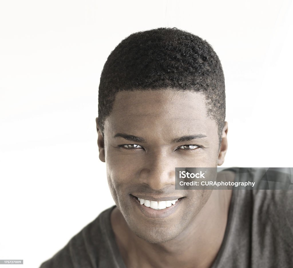 Smiling man Young happy man with big natural smile against white background Fashion Model Stock Photo