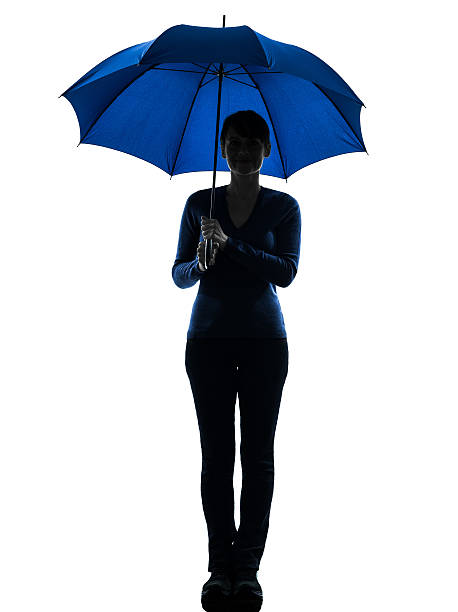 istock woman holding umbrella smiling silhouette 175728135
